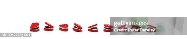 line of toy chattering teeth - clockwork toy stock pictures, royalty-free photos & images