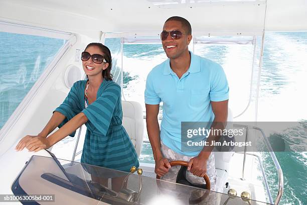 couple driving speedboat - speedboat foto e immagini stock