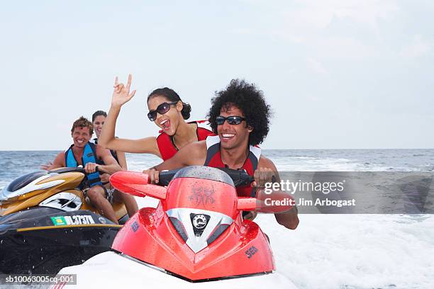 two couples riding jet boats - jet ski - fotografias e filmes do acervo