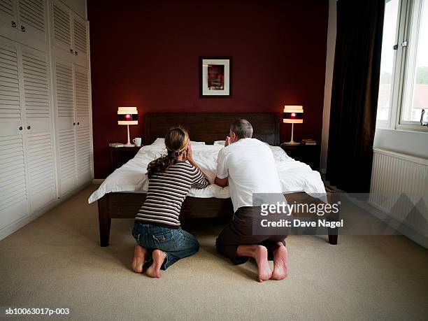 mature couple kneeling by bed, praying, rear view - couple praying stock pictures, royalty-free photos & images