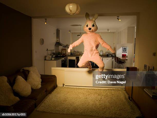 person in rabbit costume jumping in room - coniglio animale foto e immagini stock