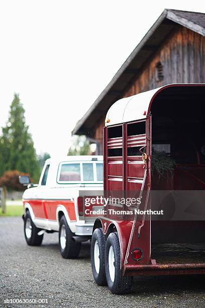 truck and horse trailer parked at stables - paardenwagen stockfoto's en -beelden