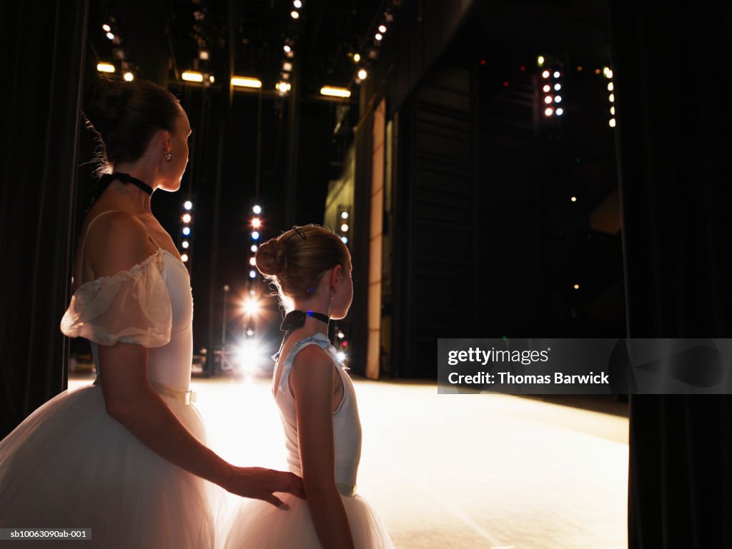 Two ballerinas standing in wings