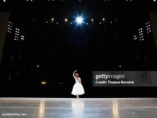 young ballerina on stage, rear view - entertainment best pictures of the day may 24 2013 stockfoto's en -beelden