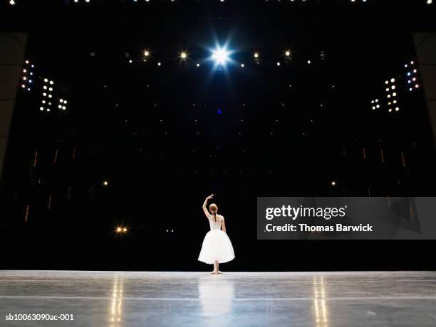 young ballerina on stage, rear view - children theater stock pictures, royalty-free photos & images