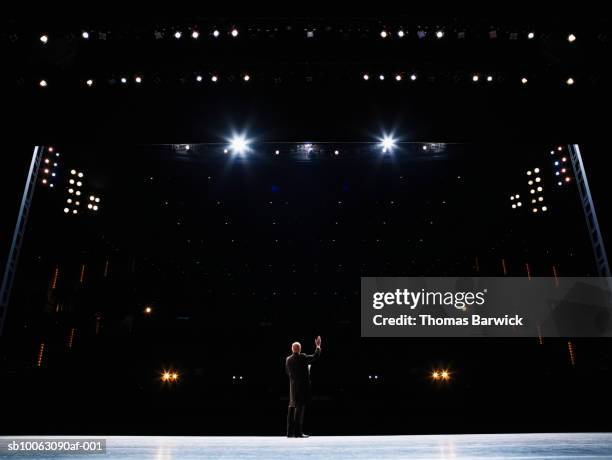 male opera singer performing solo on stage, arm raised, rear view - theatrical performance imagens e fotografias de stock