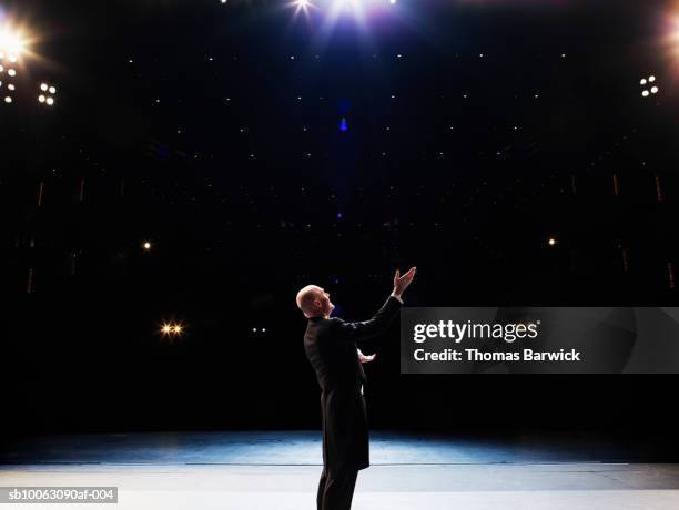 male opera singer performing solo on stage - solo performance stockfoto's en -beelden