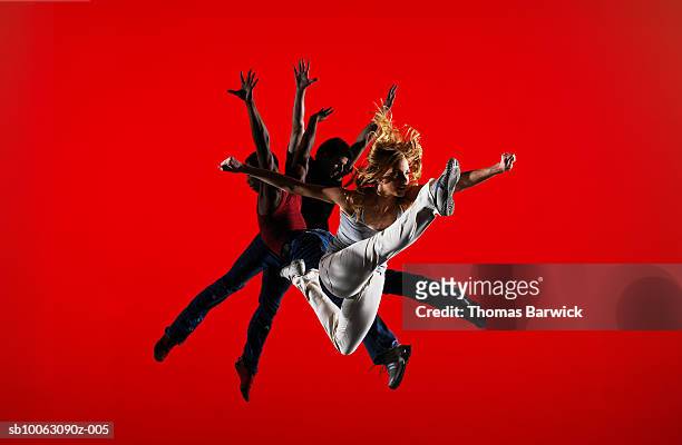 three dancers leaping on stage - show jumping stock pictures, royalty-free photos & images