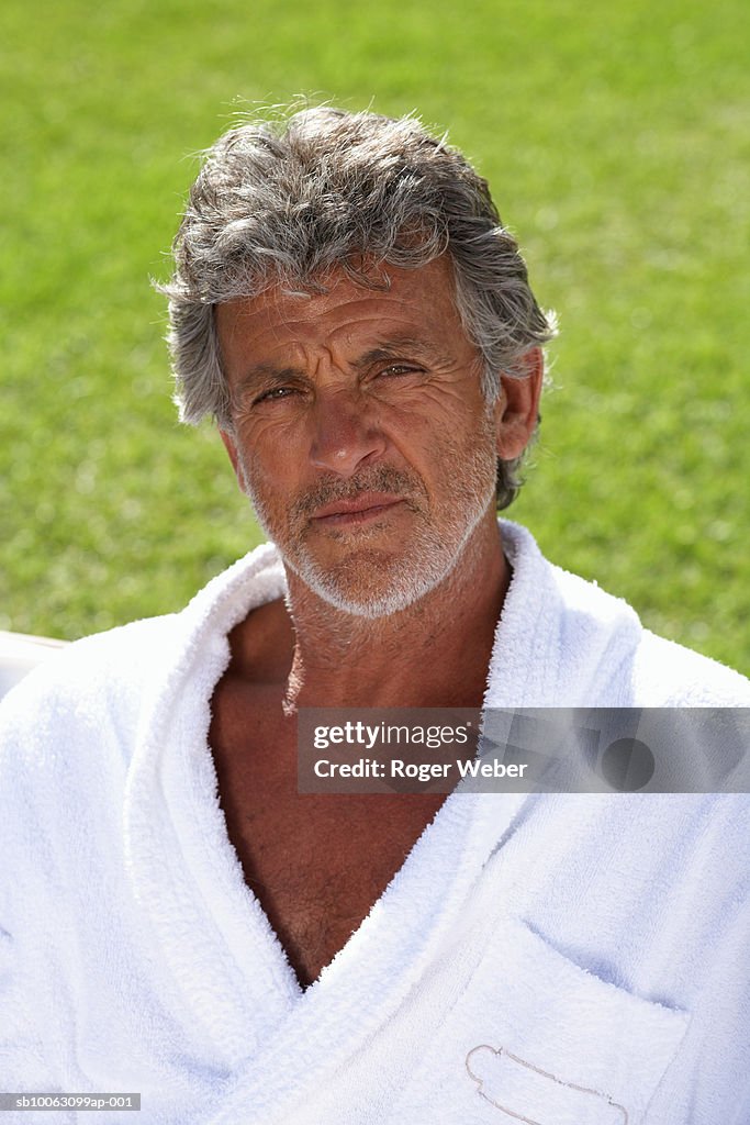 Portrait of senior man in bathrobe outdoors