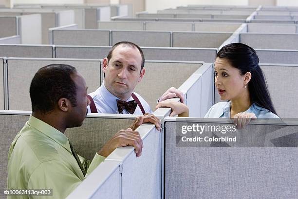 two men and woman talking in office cubicle - cubicle stockfoto's en -beelden