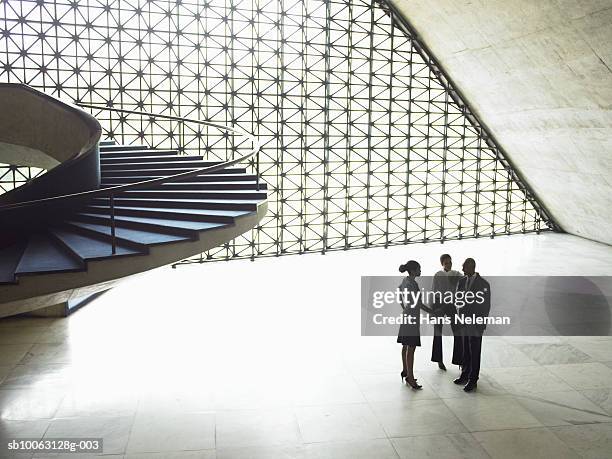 three business people meeting in office, elevated view - mid distance stockfoto's en -beelden