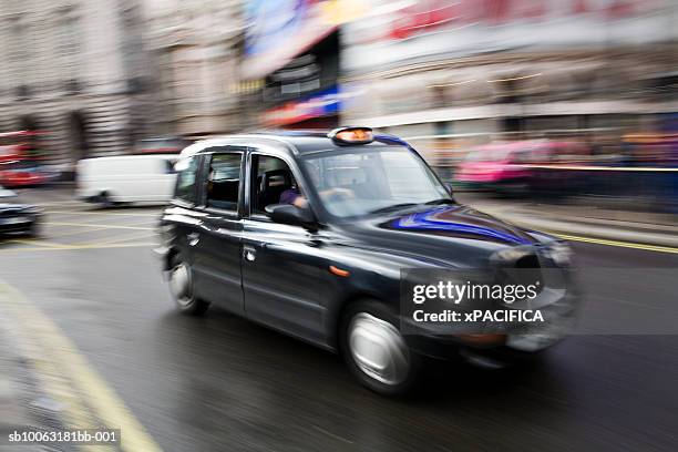 england, london, taxi on street, blurred motion - london taxi stock-fotos und bilder
