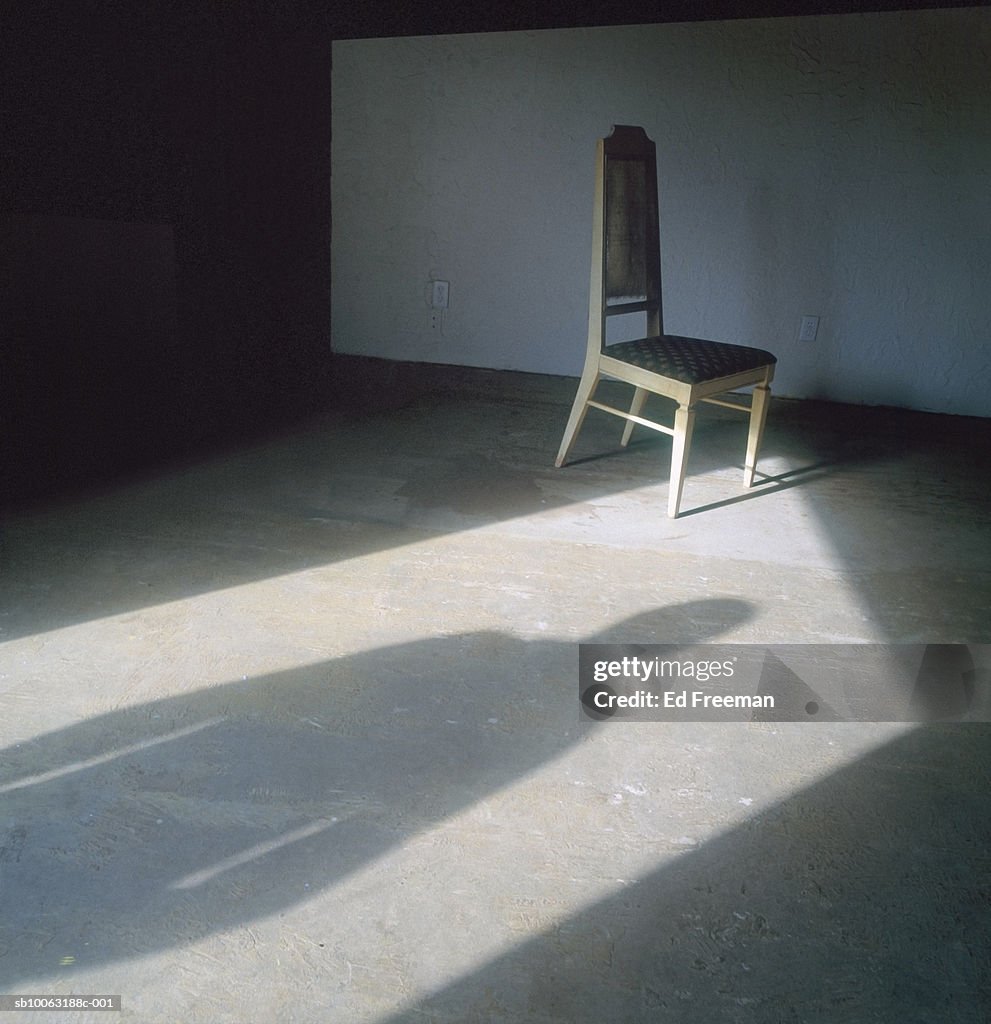 Person standing in doorway shadow on floor
