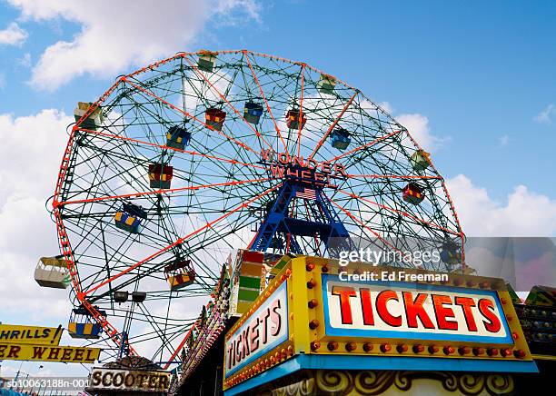 ferris wheel at amusement park, low angle view - coney island stock pictures, royalty-free photos & images