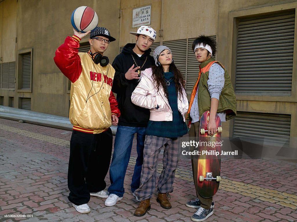 Group portrait of teenagers (17-1() and young adults in street