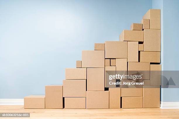 cardboard boxes stacked one on another in shape of stairs - cardboard box stock pictures, royalty-free photos & images