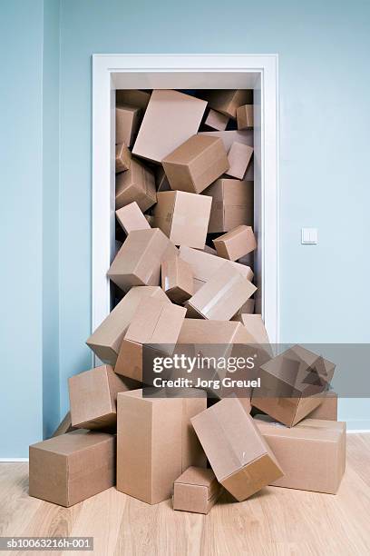 cardboard boxes coming out of doorway - overfull stock pictures, royalty-free photos & images