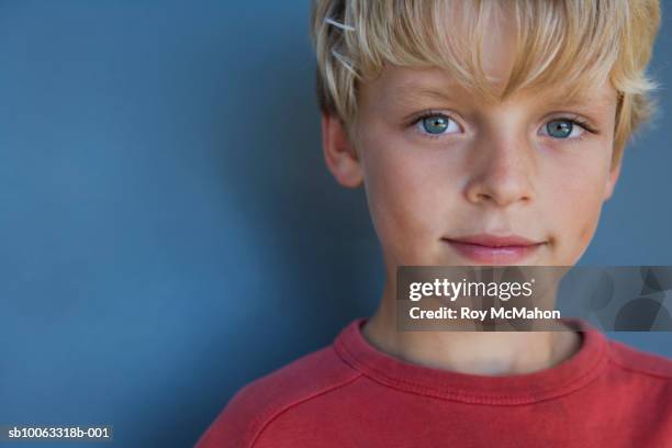 boy (10-11 years) against blue background, portrait, studio shot, close up - 10 11 years ストックフォトと画像