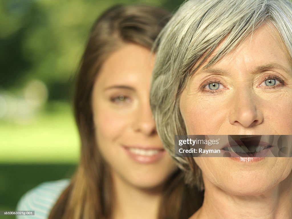 Mother and daughter (16-17), focus on mother, close-up, portrait