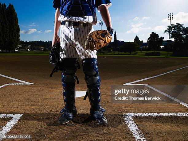 teenage boy (13-14)  baseball catcher at home plate, low view - baseball uniform stock pictures, royalty-free photos & images