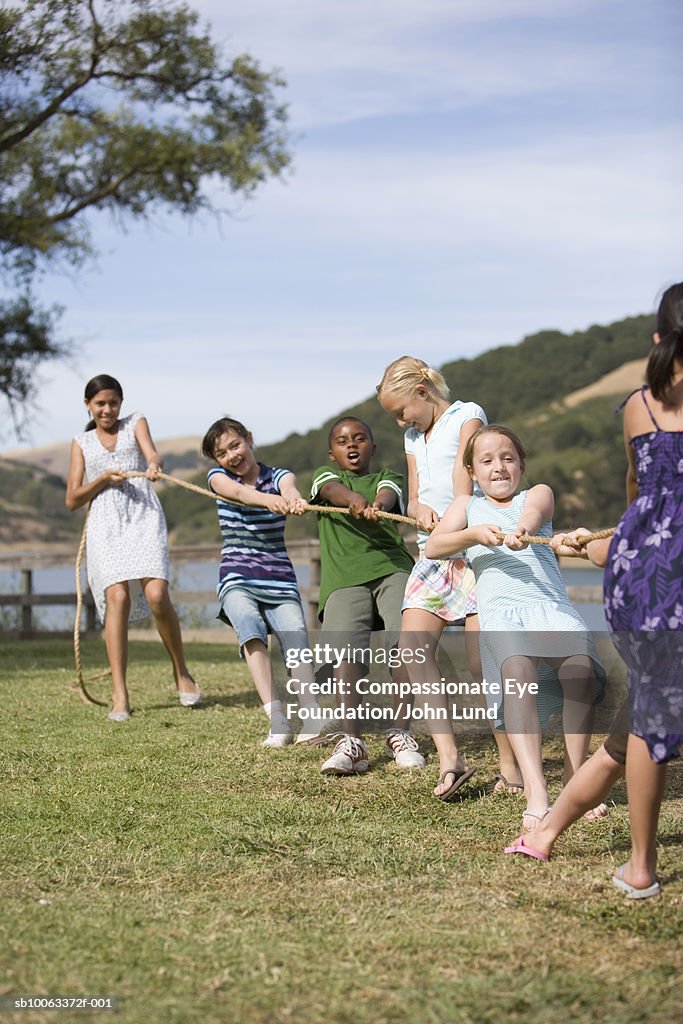 Group of children (9-13 years ) playing tug of war