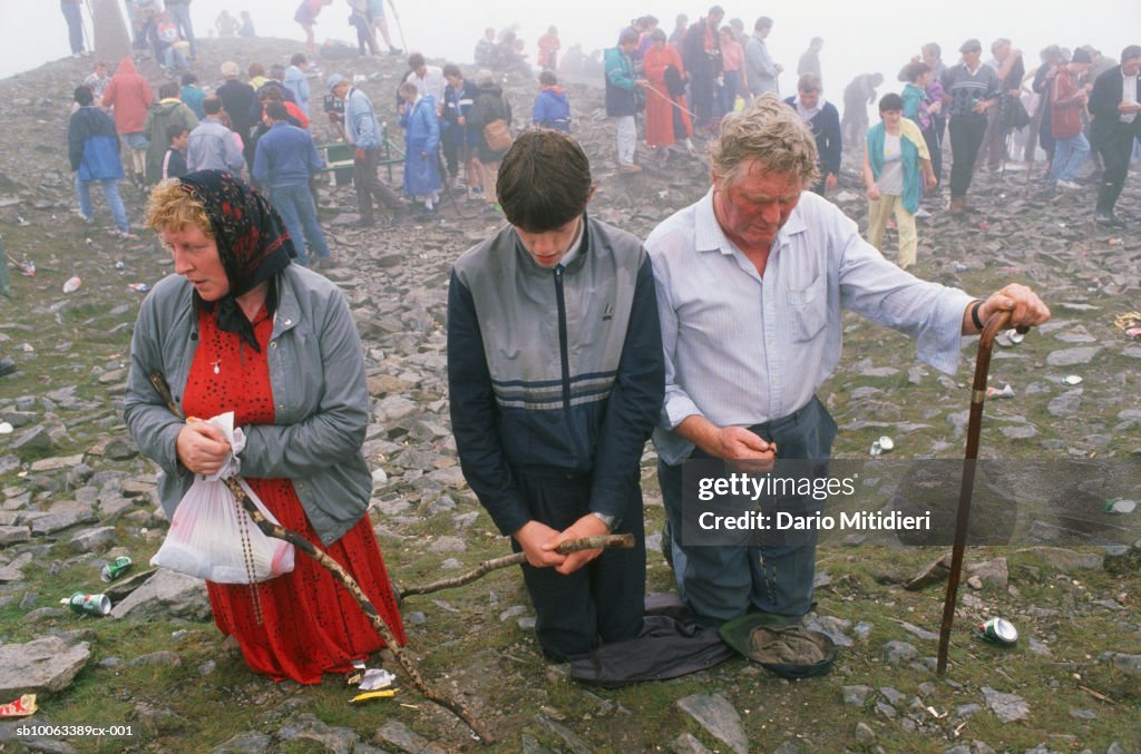 Ireland, County Mayo, people praying at Craogh Patrick