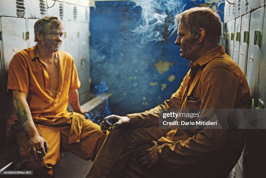 Miners having cigarette break in locker room