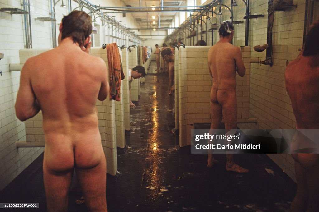 Miners showering after shift, rear view