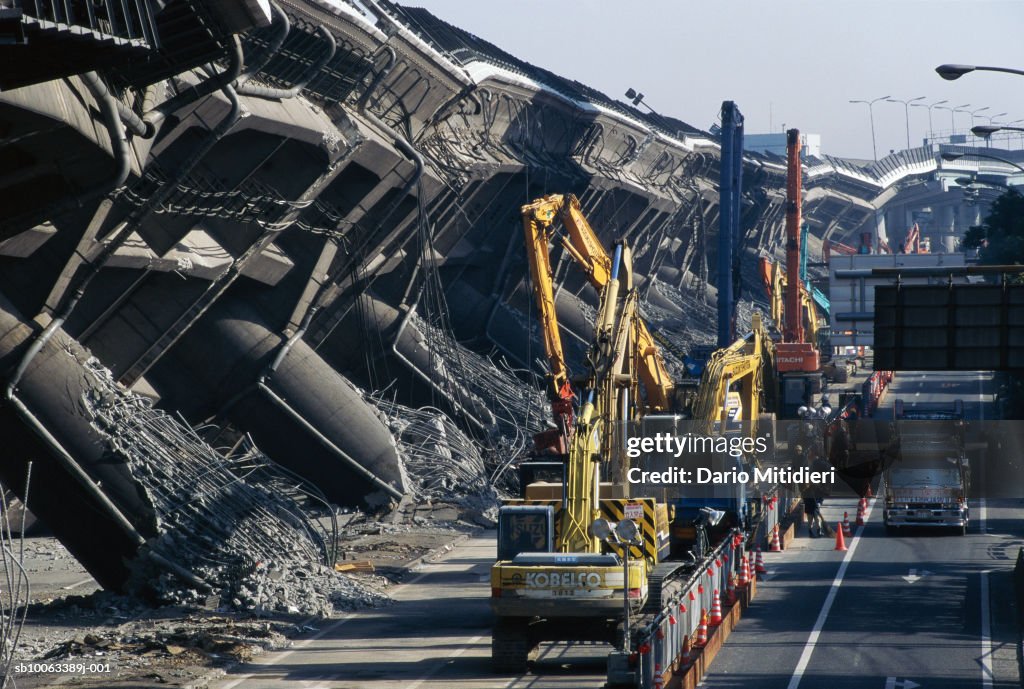 Japan, Osaka, Kobe, cranes by overpass destroyed during earthquake