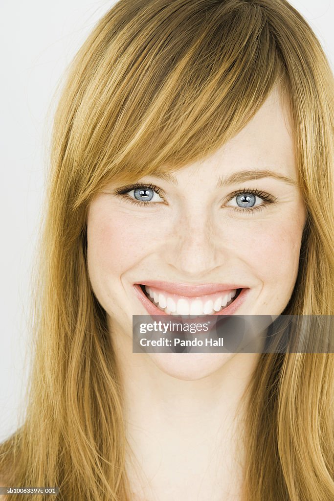 Young woman smiling, portrait, close-up