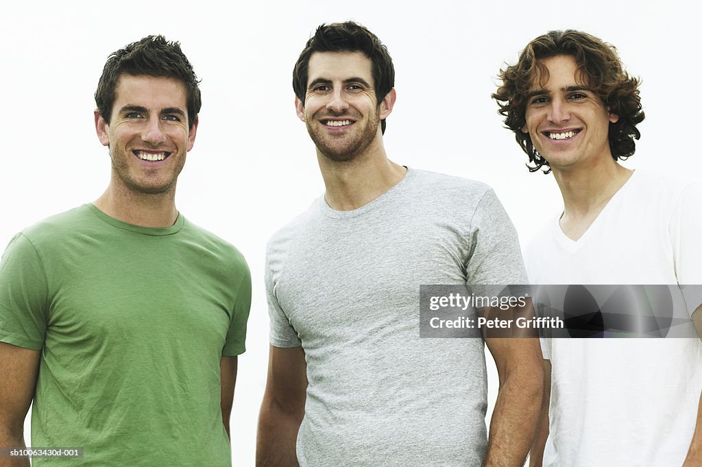 Three young men smiling, portrait