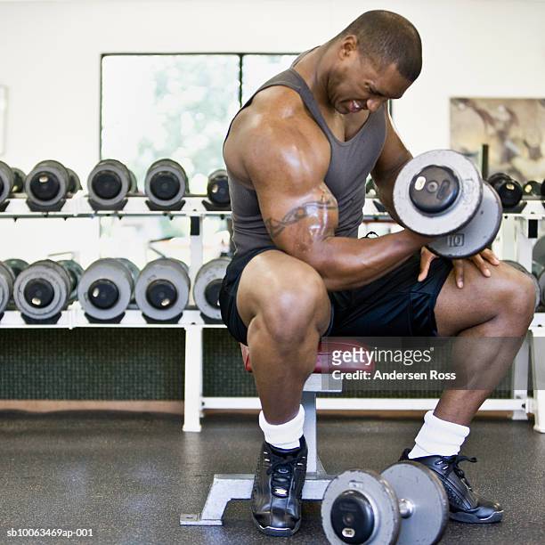 man weight training in gym - weight bench stock pictures, royalty-free photos & images