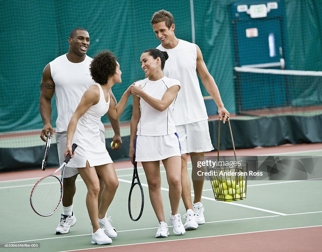 Tennis players walking in indoor tennis court