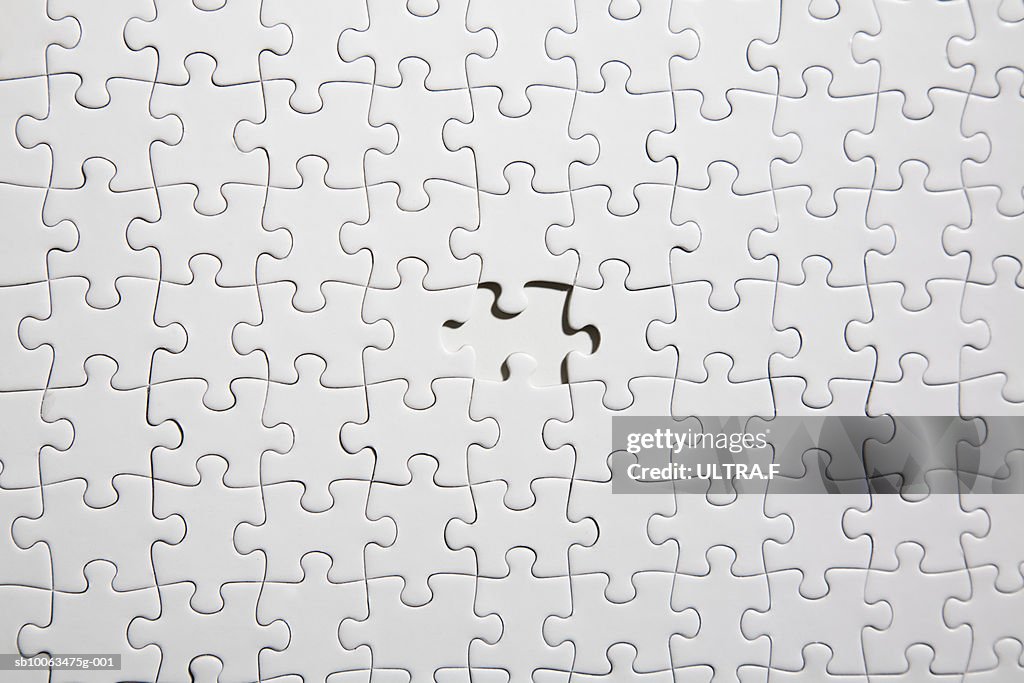 White jigsaw puzzle with one piece missing (full frame)