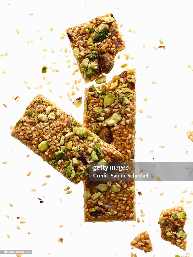 Broken cereal bars on white background