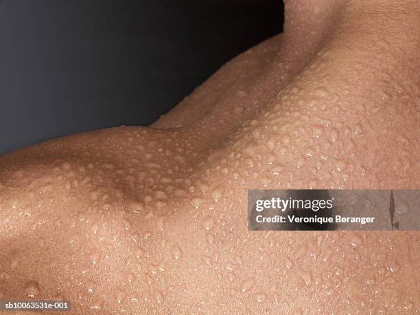 man with wet shoulder, close-up, mid section - clavicle stock pictures, royalty-free photos & images