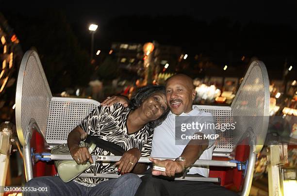 mature couple on ferris wheel, night - man ferris wheel stock pictures, royalty-free photos & images