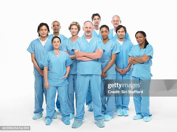 group portrait of doctors in scrubs on white background - doctor standing foto e immagini stock