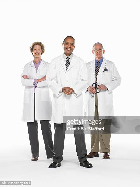 three doctors standing on white background, portrait - three female doctors stock pictures, royalty-free photos & images