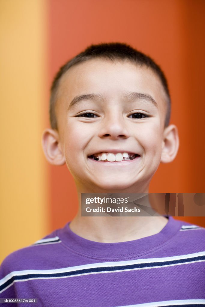 Boy (8-9) grinning, portrait