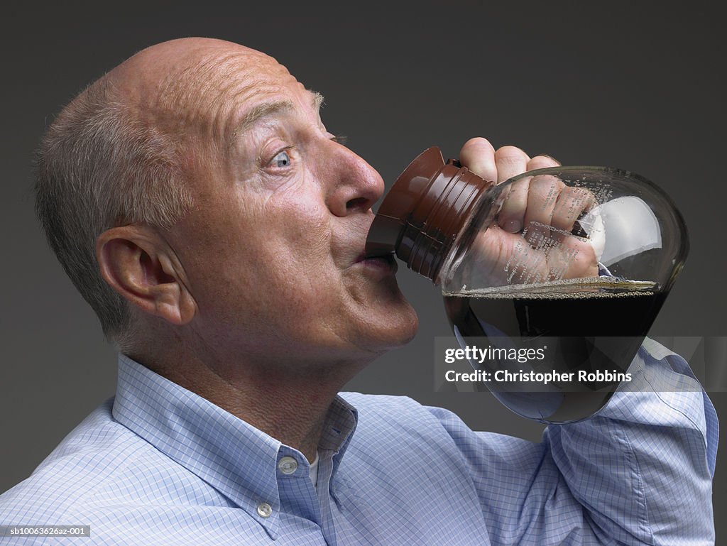 Senior man drinking coffee from pot