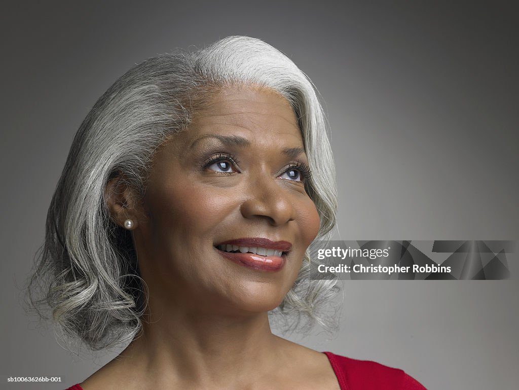 Mature woman looking away and smiling, close-up