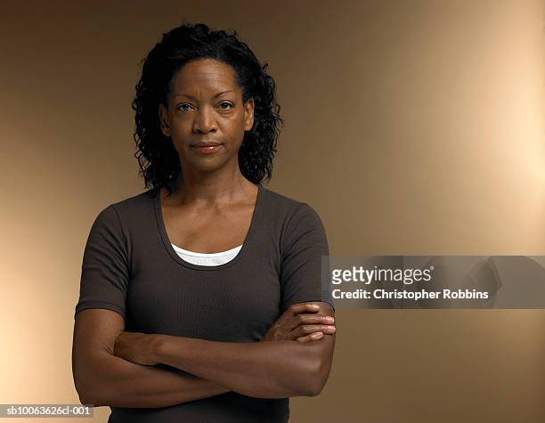 mature woman standing with arms crossed, portrait - serious stock pictures, royalty-free photos & images