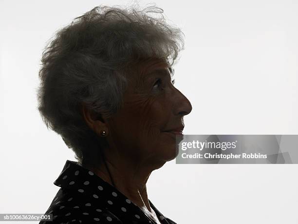 senior woman silhouetted against white background, profile, head and shoulders - profile woman silhouette imagens e fotografias de stock