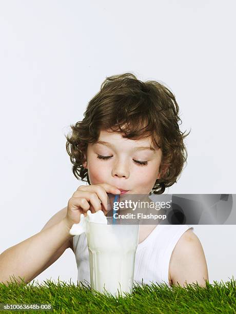 boy (6-7) drinking milk on grass, portrait - vest stock pictures, royalty-free photos & images