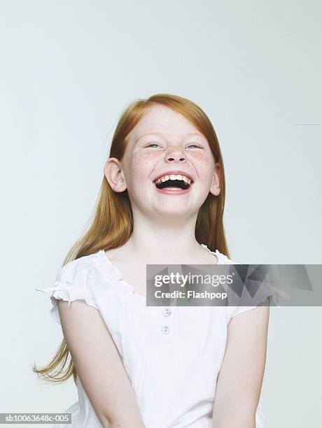 girl (8-9) laughing, close-up - blond hair girl fotografías e imágenes de stock