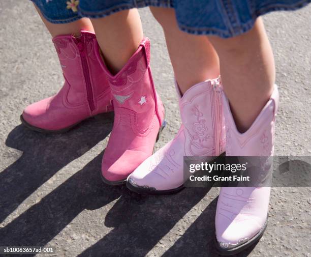 two girls in pink boots at calgary stampede parade, close-up, low section - calgary stampede stock pictures, royalty-free photos & images