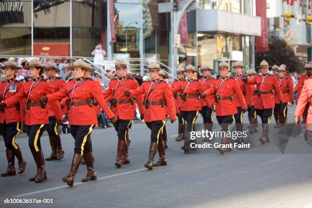 royal canadian mounted police marching calgary stampede parade - parede stock pictures, royalty-free photos & images