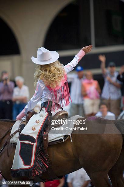 girl riding on horse at calgary stampede parade - girl and blond hair and cowboy hat stock pictures, royalty-free photos & images