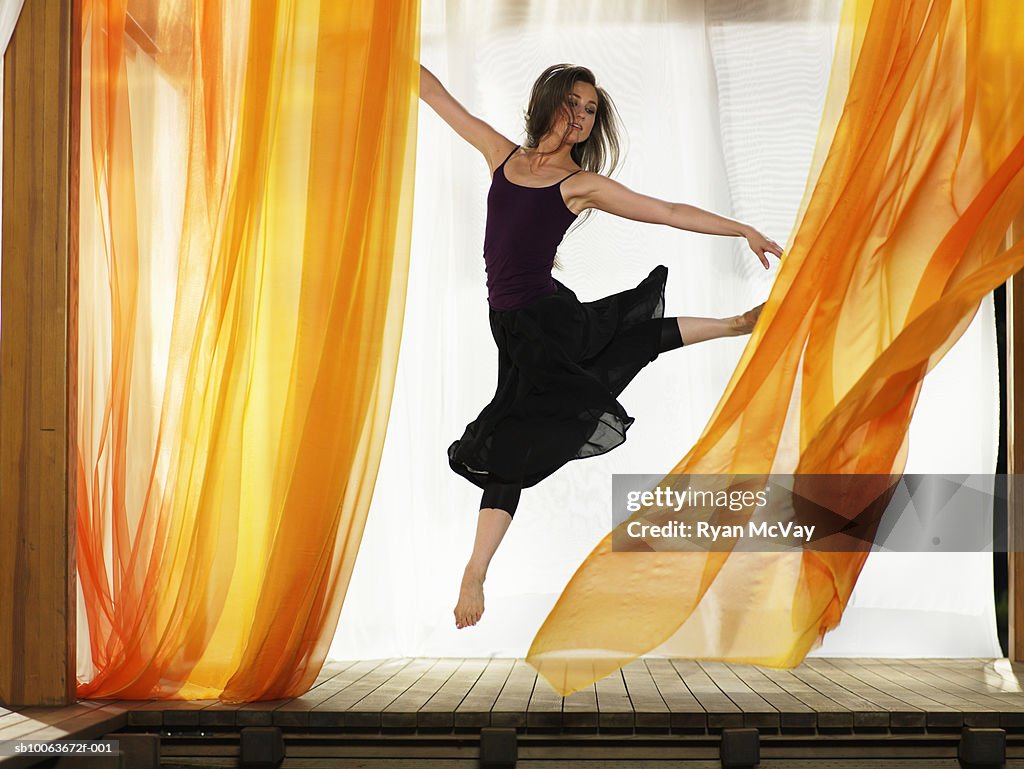 Young woman dancing, arms outstretched